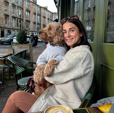 Kate and her dog at a coffee shop.
