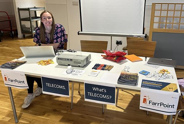nikki robertson at a desk at orkney science festival talking about telecoms