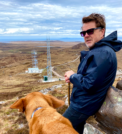 Andrew with his dog Sam with masts in background